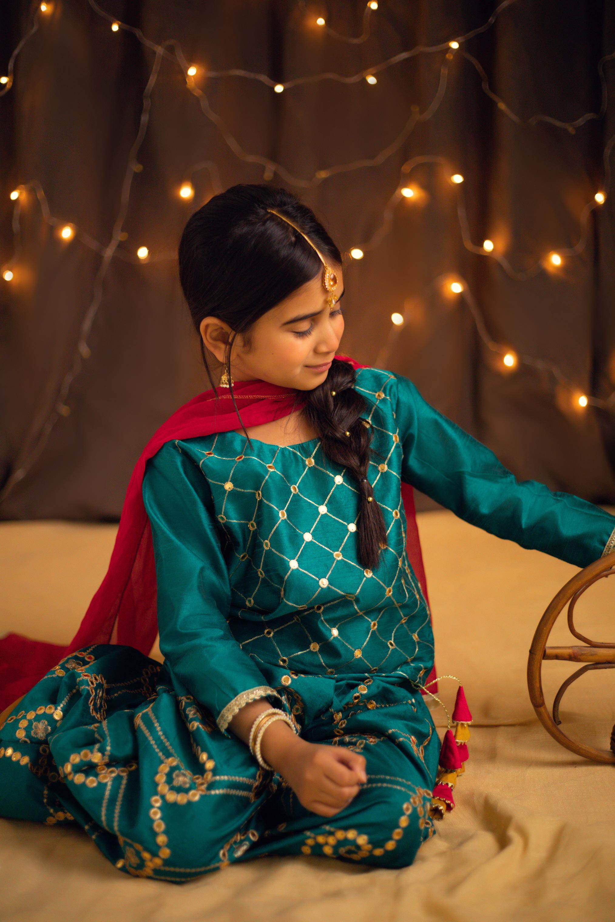 Teal colored plazo and short shirt with golden embroidery and pink contrast dupatta